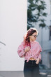 © WellStock - Portrait of young beautiful girl wearing stylish shirt, black skinny jeans, glasses. Girl have shinny long red hair. Female fashion concept