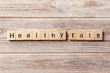 Healthy fats word written on wood block. Healthy fats text on table, concept
