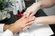 © Artem Zakharov - Massage after the manicure. Male and female hands macro.