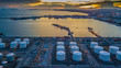 Aerial view oil terminal construction with industrial crane port facility for storage oil and petrol chemical ready for transport to harbor further storage, Cargo industry port ship.