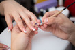 © Artem Zakharov - Closeup shot man making manicure to woman in beauty salon