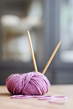 Purple Ball Of Yarn With Knitting Needles