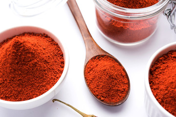 Poster - Red Chilly Powder in a bowl with dried red chillies over colourful background or pile of red chilli powder over plain background

