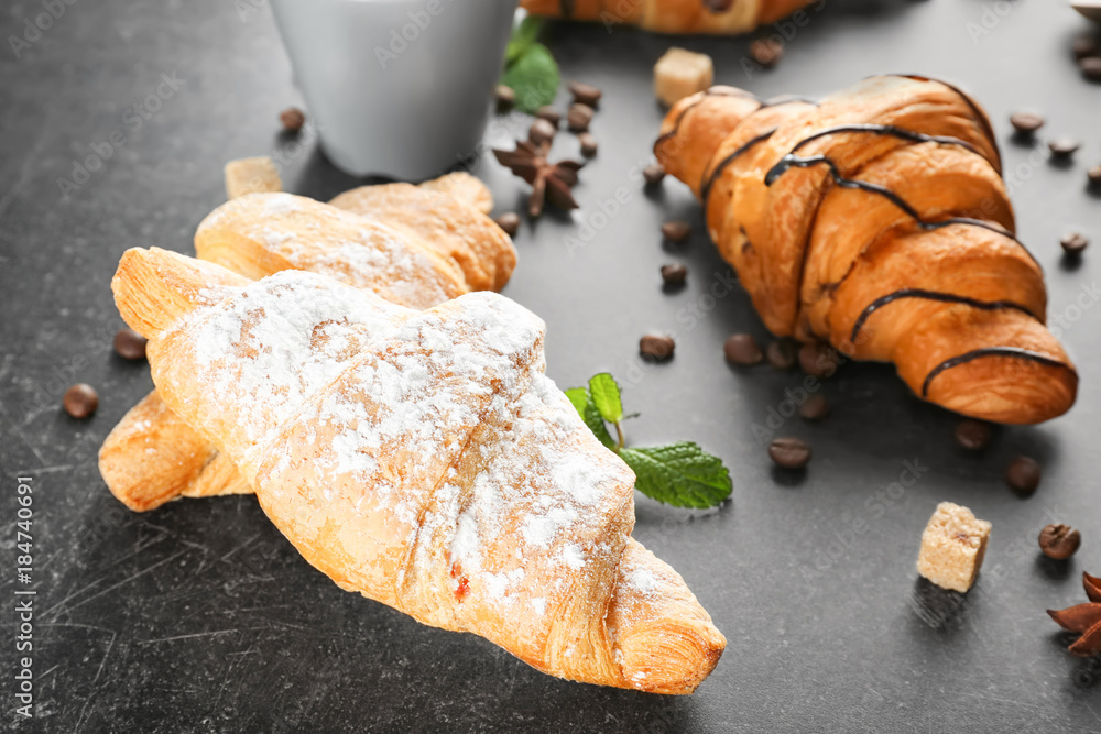 Delicious sweet croissants on table