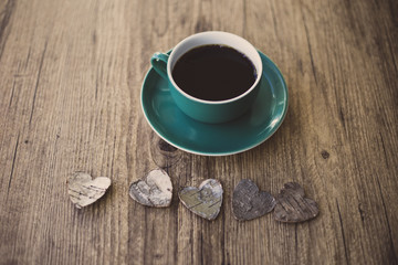 Black coffee and wooden hearts