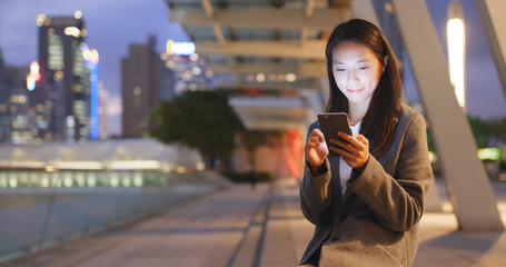 Poster - Woman sending sms on cellphone at night