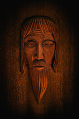 Wall Mural - carved wooden mask of an old man in the old Slavic style closeup