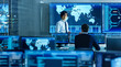 © Gorodenkoff - In the System Control Room Manager Holds a Briefing for His Staff Member. They're Work in Data Center and are Surrounded by Multiple Screens Showing Maps, Logistics Data.
