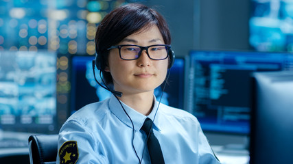 Poster - In the Network Operations Center Senior Trader Teaches Young Associate to Makes Personal Client Call with a Headset. They're Surrounded by Monitors Showing Data and Graphs.