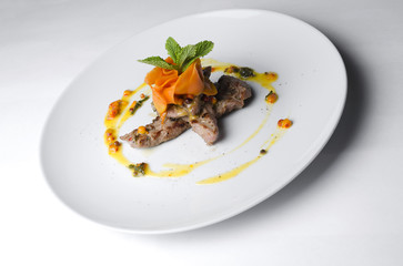 Wall Mural - Turkey with sea buckthorn sauce on a white plate