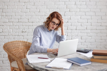 Wall Mural - the women is stressed at work in the office. The business woman very serious in front of her laptop in the office