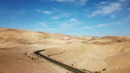 Wall Mural - Desert road - Aerial footage of a new two lane road surrounded by dry desert landscape