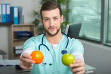 Nurse Or Male Doctor Showing Fruits
