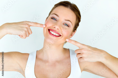 Fotografía Beautiful young woman with perfect smile. Isolated on white.