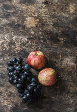 Fresh Ripe Autumn Fruit Apples And Grapes On Rustic Wooden Background, Top View. Free Space For Text