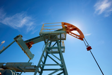 Wall Mural - Pumpjack. A pumpjack is the overground drive for a reciprocating piston pump in an oil well. The arrangement is commonly used for onshore wells producing little oil. 