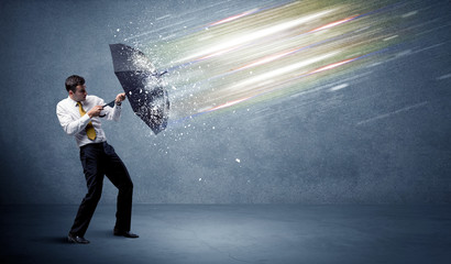 Wall Mural - Business man defending light beams with umbrella concept