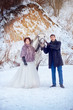 © pushann - Wedding portrait of the wife and  groom  near a white horse on a winter day during a snowfall