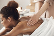 © Cookie Studio - Attractive african girl having massage relaxing in spa salon. Closed eyes.