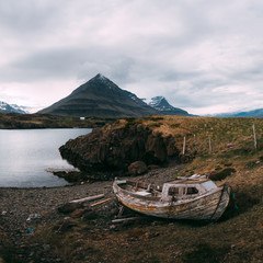 Wall Mural - Typical Iceland landscape with fjord, mountains and old ship