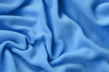 The blanket of furry blue fleece fabric. A background of light