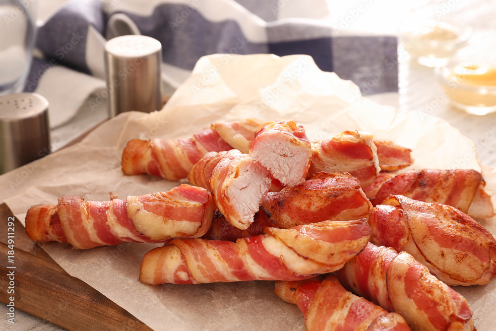 Bacon wrapped chicken nuggets on wooden board