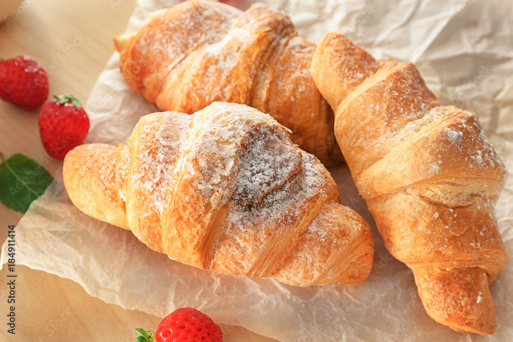Tasty croissants on table, closeup