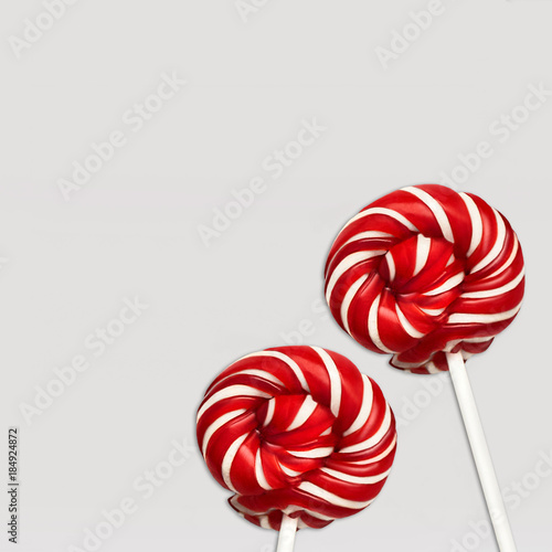 Download Lollipops Top View Minimal Concept Two Colored Lollipops Are Lying On White Background Classic Round Red White Candy On A Stick Photo Mockup For Banner Poster Web Stock Photo Adobe Stock