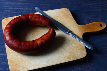 Poster - Round sausage on board and knife