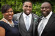 African American bride and groom with family.
