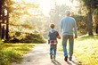 © Sergii - Grandfather and grandson together outdoors family concept