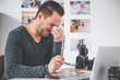 © Yakobchuk Olena - Side view weary unshaven male working at desk in apartment. Fatigue concept