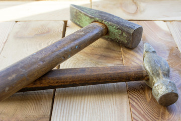 Construction hammers on a wooden board