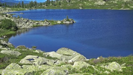 Wall Mural - Panorama of a blue mountain lake surrounded by wooded peaks. Western Siberia, Ergaki range. 