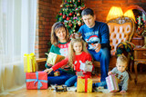 Fototapeta Panele - a large friendly family gives each other presents sitting near the Christmas tree.