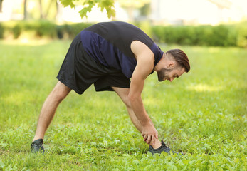 Wall Mural - Sporty young man training outdoors