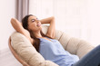 © Africa Studio - Young woman resting in lounge chair at home