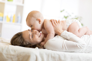 Adorable baby kissing his mother