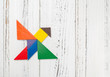 © Freer - wooden tangram shaped like a flying bird with copy space