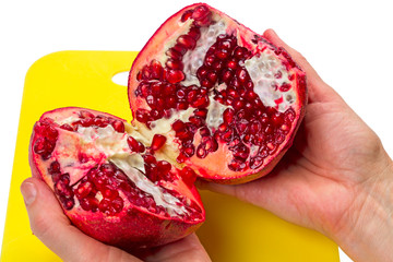 Wall Mural - Two halves of a pomegranate in the hands