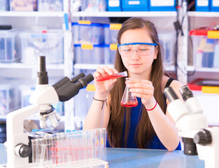 Canvas Print - A teenage girl in a school laboratory in chemistry and biology classes