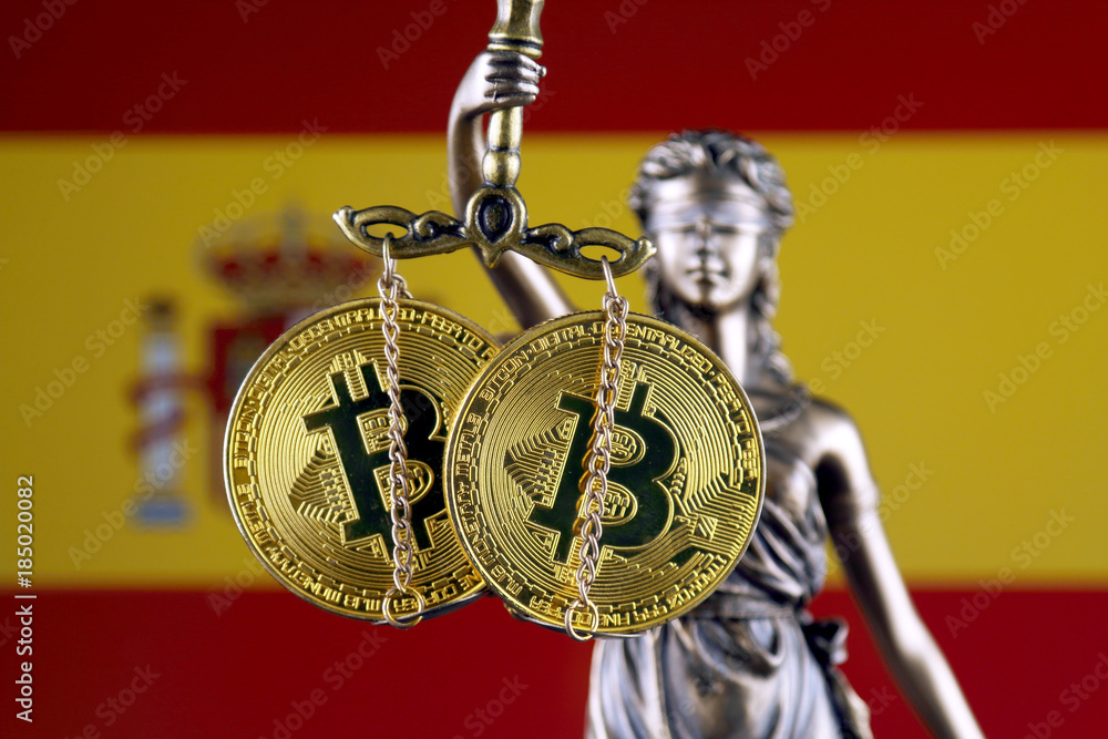 Symbol of law and justice, physical version of Bitcoin and Spain Flag. Prohibition of cryptocurrencies, regulations, restrictions or security, protection, privacy.
