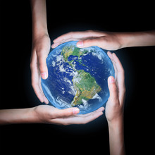 Four Hands Save The World On Black Background ,Elements Of This Image Furnished By NASA