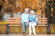 © Africa Studio - Cute elderly couple sitting on bench in autumn park