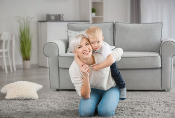 Canvas Print - Attractive young mother playing with her baby at home