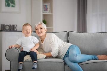 Canvas Print - Attractive young mother with her baby on couch at home