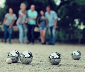 Image of people playing petanque on sand