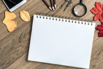 Open notebook with white blank sheets on wooden table,Top view