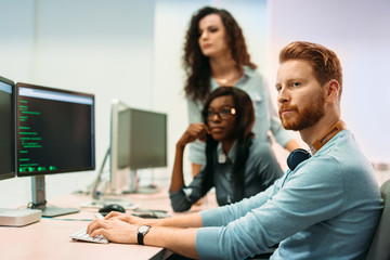 software engineers working on project and programming in company
