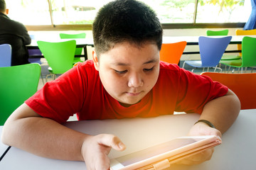 Asian child Boy are addictive playing tablet and mobile phones, Game Addiction